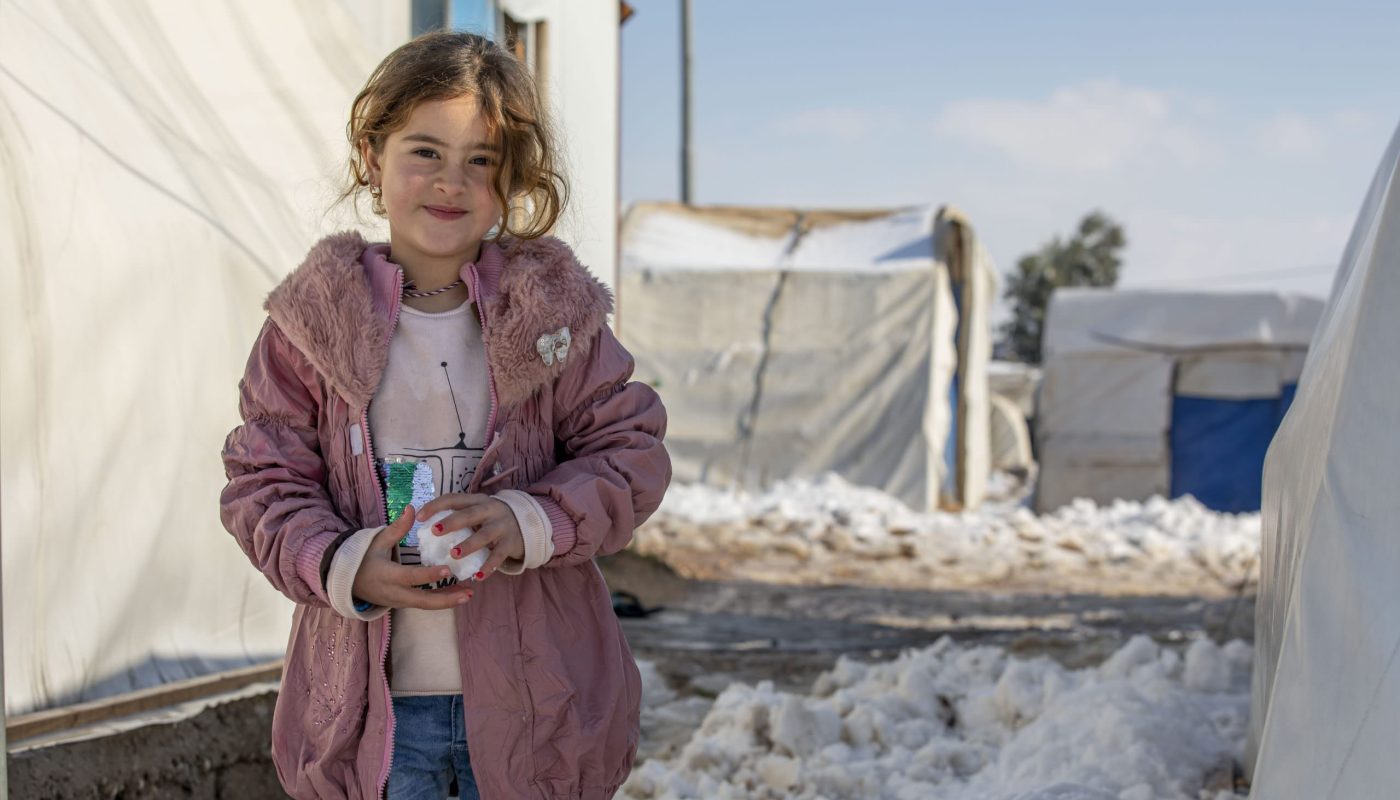 Girls playing with snow outside their shelter at Essian IDP camp near Duhok in Kurdistan Region of Iraq. ; This year (2022) low temperature drops have been recorded in Iraq, with temperatures dropping to subzero reaching -8 Celsius in several provinces in the northern mountainous regions in Kurdistan Region of Iraq. Extreme cold has been witnessed in some IDP camps, making it very difficult and unbearable for those most vulnerable, as there is nothing but thin walls or sometimes plastic sheets to protect them from the severe cold. In the last few days, the government announced public holidays on more than one occasion and schools were closed to protect children from the elements. More snowstorms are expected in the coming weeks, amid very low temperature. UNHCR distributed cash assistance for fuel and other emergent needs, to help the most vulnerable refugees and IDP families prepare for winter and purchase fuel for heating but as temperatures continue to drop more help is needed.