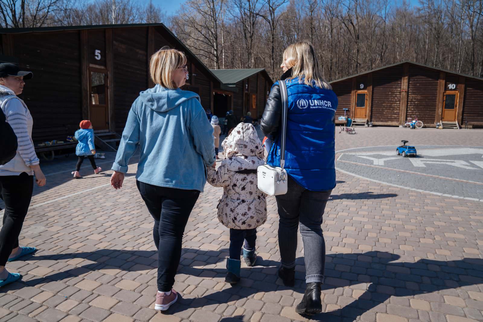 UNHCR staff member comforts two displaced boys who found refuge at the “Your Camp” reception centre for displaced people in a village in the Chernivtsi region in western Ukraine. UNHCR has provided bed linen at the centre which hosts 200 displaced people per day. ; UNHCR has been present in Ukraine since 1994, working closely with the Ukrainian government and civil society in responding to forced displacement. It works closely with local authorities and humanitarian partners. Efforts are focused on protection, shelter, and cash and in-kind assistance. More than 4.5 million refugees have fled to neighbouring countries since the war started on 24 February 2022. Inside the country, more than 7 million people are estimated to have been displaced.