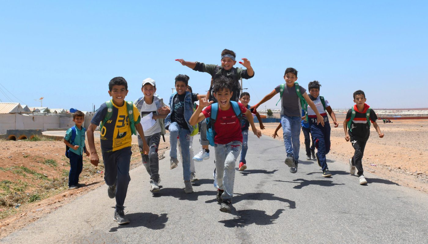 Kids going to school in Azraq camp while temperature hits 45+ with the beginning of summer season. ; Eight years since its establishment, Azraq camp is a home for 40K refugees.